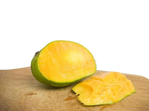Mango halved placed on wood. so that the inside is visible in orange .isolate Stock Photos