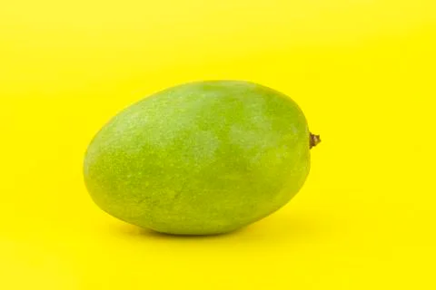 A mango isolated on yellow background. Stock Photos