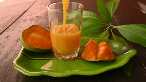Mango juice with mango slice isolated on black background. Stock Footage 244633854