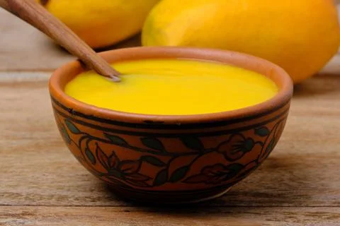 Mango juice or shake in bowl Stock Photos