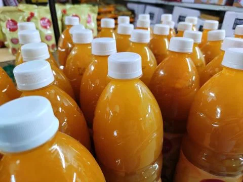 Mango juice packed softdrinks bottle closeup view in market for sale. Stock Photos