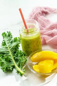 Mango kale smoothie on table Stock Photos