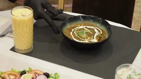 Mango lassi garnished with coconut flakes and spices served in an indian Stock Footage 305217982