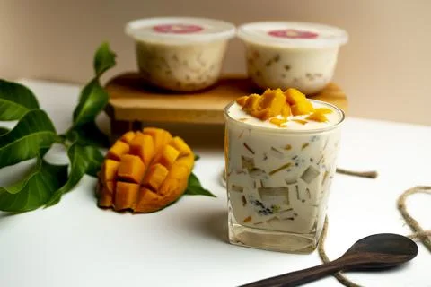 Mango Milk Cheese with a half of mango on white table Stock Photos