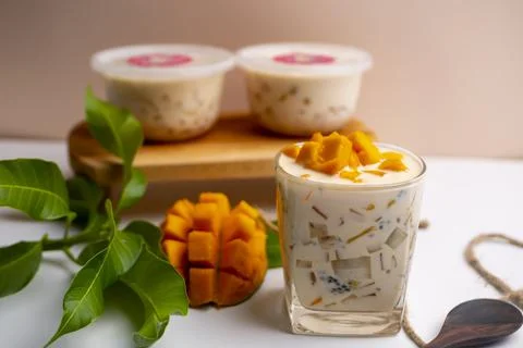 Mango Milk Cheese with a half of mango on white table Stock Photos