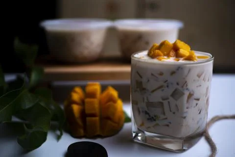Mango Milk Cheese with a half of mango on white table Stock Photos