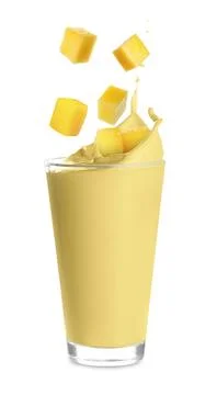 Mango milkshake and pieces of fresh fruit on white background Stock Photos