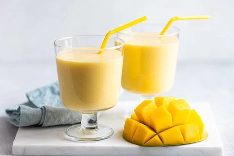 Mango milkshake in a glass, selective focus Stock Photos