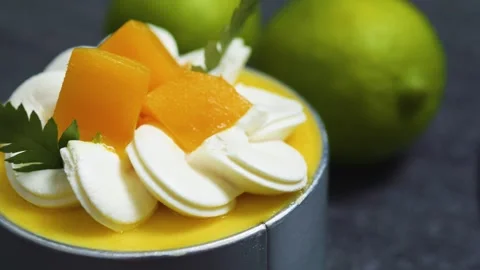 Mango mousse cake Tin Can layered with velvety whipped cream, garnished by fresh Stock Footage 313291745