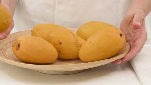 Mango, peach fruit salad with pine nuts and mint leaf. Closeup accelerated video Stock Footage 132557627