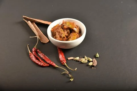 Mango pickle garnish with spices.A mango pickle is a variety of pickle prepar Stock Photos