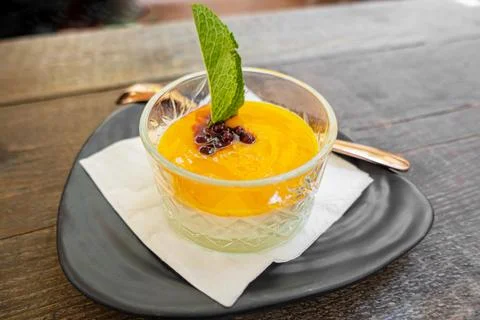 Mango puree and mint leaf in glass Stock Photos