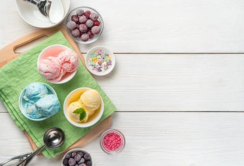 Mango, raspberry and blueberry flavored ice cream on a light background with Stock Photos