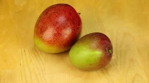 Mango rotates on a wooden background Stock Footage 57049184