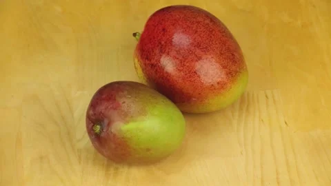 Mango rotates on a wooden background Stock Footage 178142360