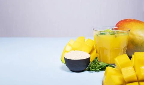 Mango Shake wit Maca on Blue Background. Healthy Drinking  Smoothie with mint Stock Photos