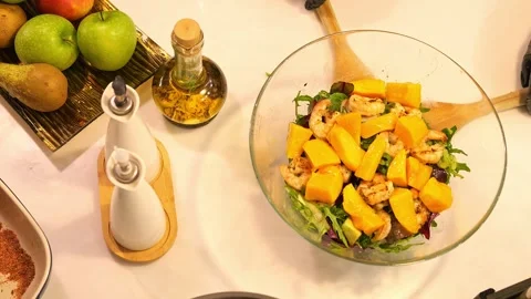 Mango shrimp and rocket salad is elegantly plated and ready to delight. Dive Stock Footage 271658231