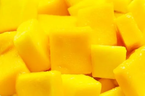 Mango slice cut to cubes background. Stock Photos