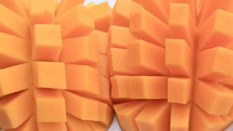 Mango slice cut to cubes close-up Stock Photos