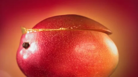 Mango Slice falling and splashing on yellow pink background. Food levitation Video stock 193079583