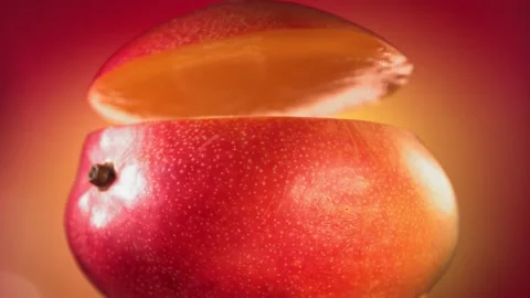 Mango Slice falling and splashing on yellow pink background. Food levitation Video stock 193081469