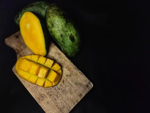 Mango slices cut into cubes on a coaster Stock Photos