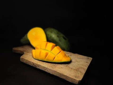 Mango slices cut into cubes on a coaster Stock Photos