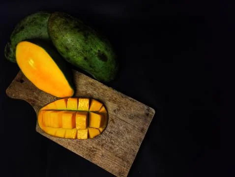 Mango slices cut into cubes on a coaster Stock Photos