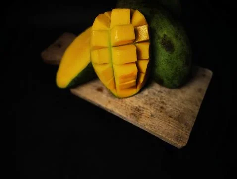 Mango slices cut into cubes on a coaster Stock Photos