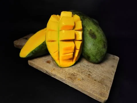 Mango slices cut into cubes on a coaster Stock Photos
