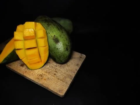 Mango slices cut into cubes on a coaster Stock Photos