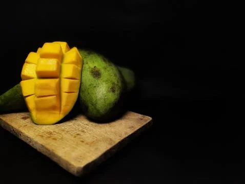 Mango slices cut into cubes on a coaster Stock Photos