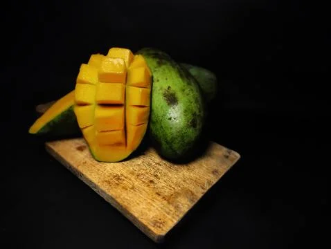 Mango slices cut into cubes on a coaster Stock Photos