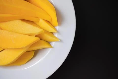 Mango slices in a white dish Stock Photos