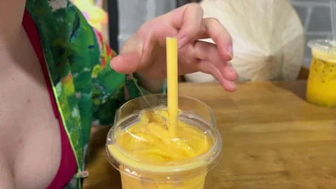 Mango smoothie and a blender on table with copy space , Stock Footage 317701413