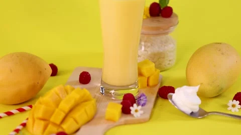 Mango Smoothie and Fresh Fruit on Bright Yellow Background Stock Footage 321384163