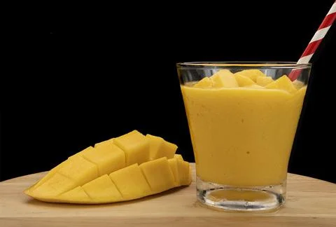 Mango smoothie with mango cubes. Stock Photos