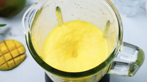Mango smoothie or milkshake blended in blender with splashes. slow motion Stock Footage 251010870