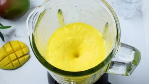 Mango smoothie or milkshake blended in blender with splashes. Slow motion Stock Footage 271238475