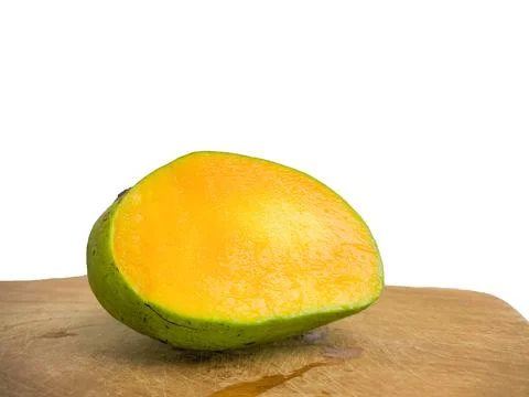 The mango is split on the wood. so that the inside is visible in orange .isol Stock Photos