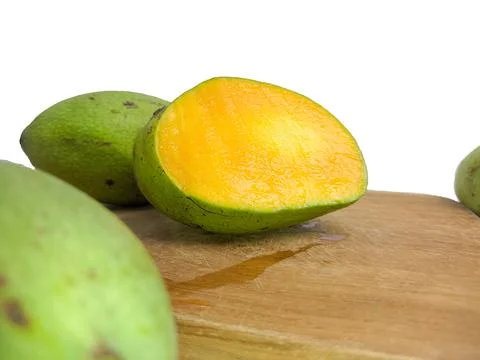 The mango is split on the wood. so that the inside is visible in orange . Stock Photos