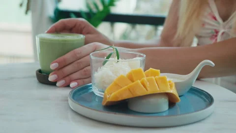 Mango Sticky Rice and Matcha Latte on Cafe Table Stock Footage 312707043