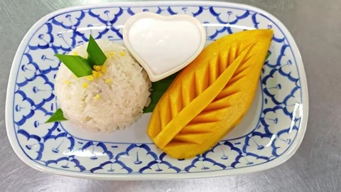 Mango sticky rice with carved mango on ceramic plate. Stock Footage 342404214