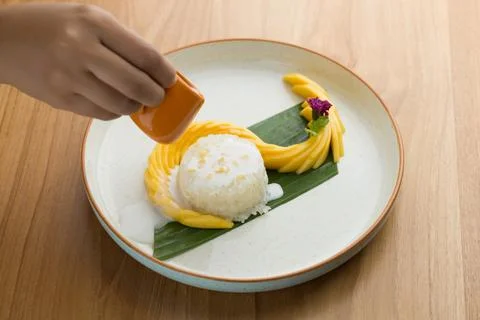 Mango sticky rice, featuring coconut milk as a key ingredient and topped wi.. Stock Photos