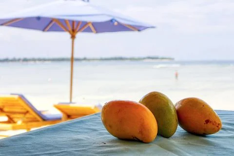 Mango on the table, beach dessert. Chilled fruit. Tonic food. Stock Photos