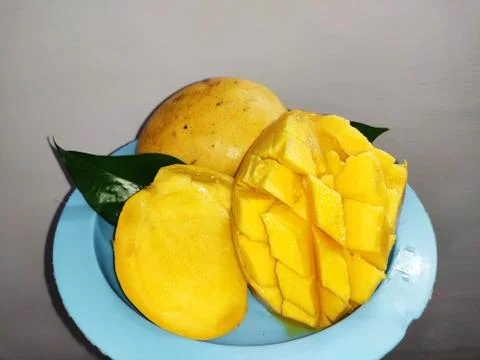 Mango on Textured bg  Stock Photos