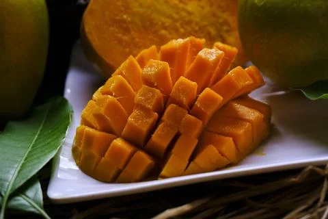 Mango tropical fruit with green leaf, Ripe mango in grass closeup Stock Photos
