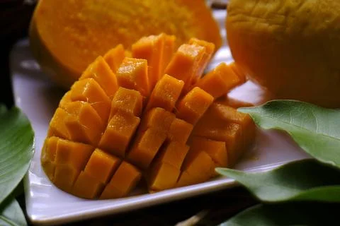 Mango tropical fruit with green leaf, Ripe mango in grass closeup Stock Photos