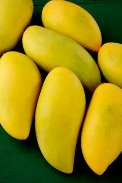 Mango on wood background Stock Photos
