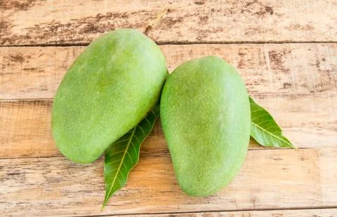 Mango on wooden background Stock Photos